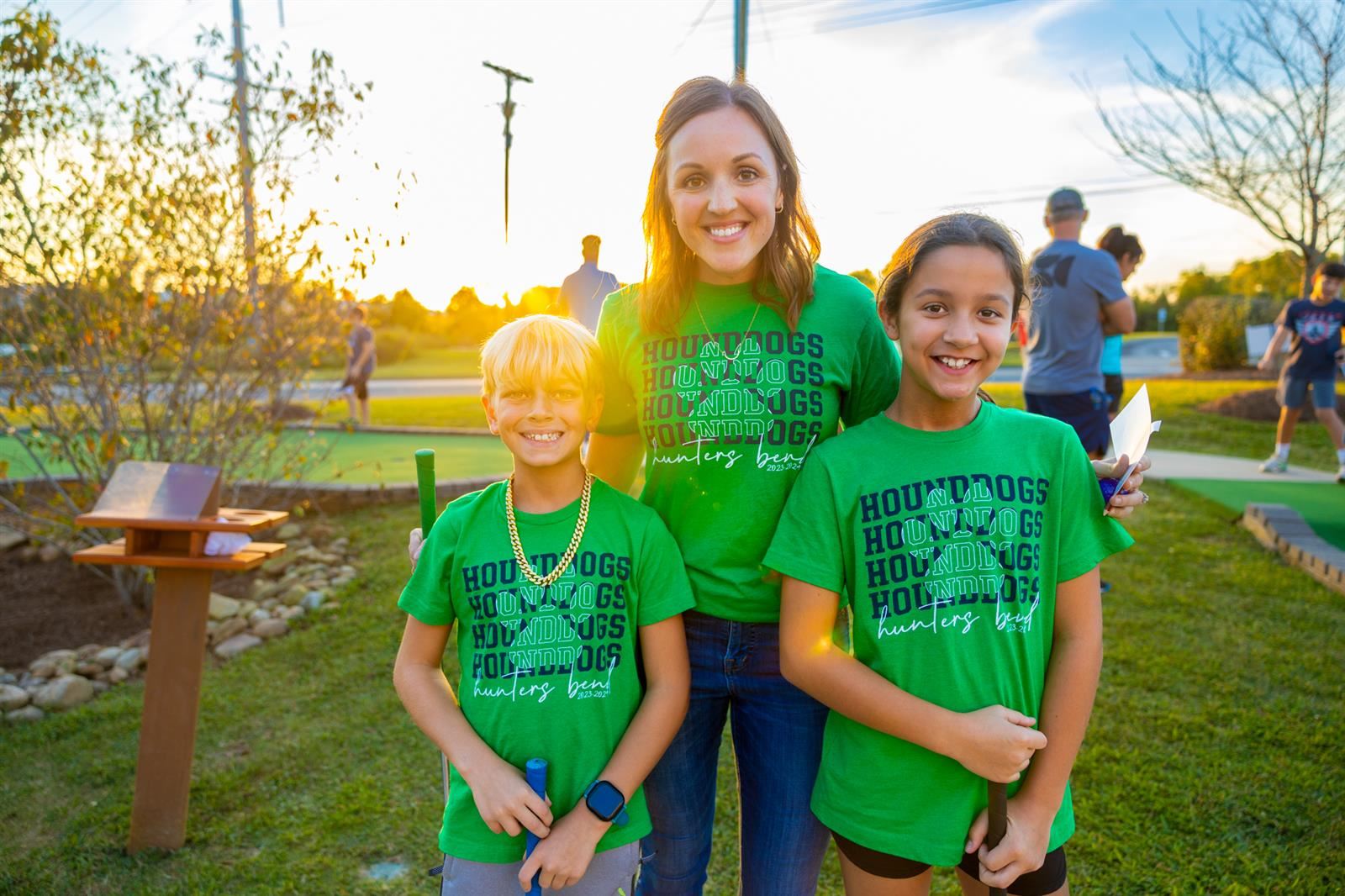 principal and two students at mini golf